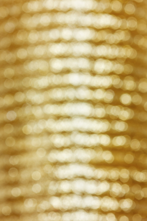 golden bokeh background, defocused holidays christmas lights on backdropの写真素材