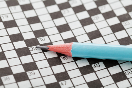 Closeup crossword puzzle and blue pencilの写真素材