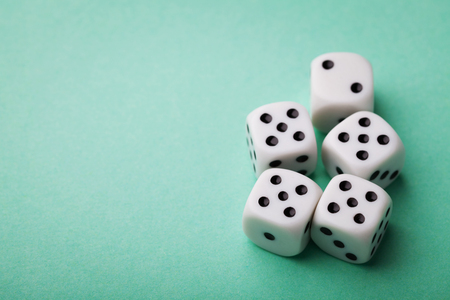 White dice on green table. Gambling devices. Copy space for text. Game of chance concept.の写真素材