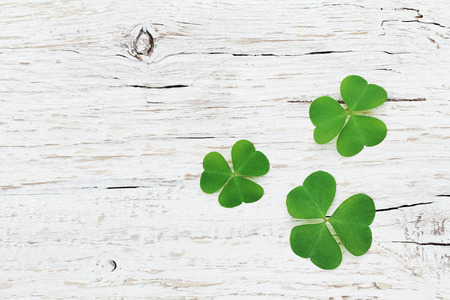 saint patricks day background with green shamrock on wooden texture top viewの写真素材