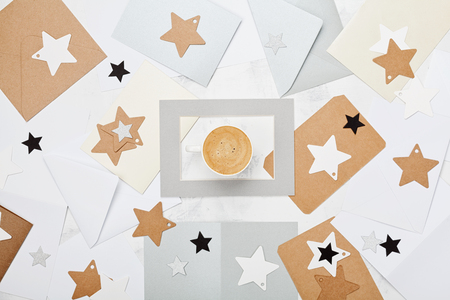 Mail correspondence background or pattern with cup of coffee and envelopes decorated stars top view. Flat lay style.の写真素材
