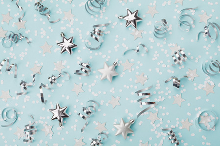 Stylish christmas background with confetti, serpentine and silver stars top view. Flat lay.の写真素材