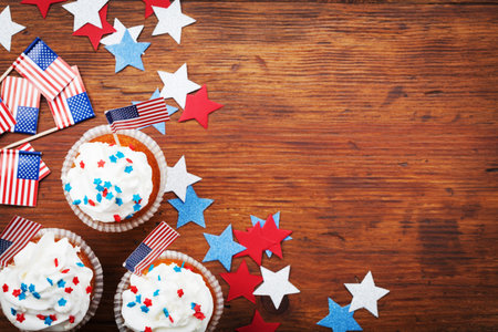 Cupcake decorated with american flag for happy Independence Day 4th july background. Holidays table top view.の写真素材