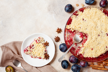 Plum crumble with cinnamon on stone table top view. Autumn pastry.の写真素材
