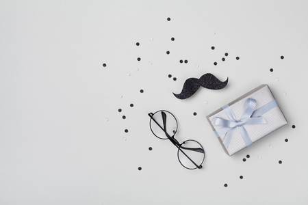 Gift or present box, moustache, glasses and confetti for Happy Father day. Top view and flat lay.の写真素材