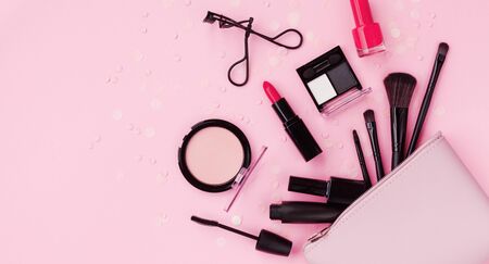 Woman makeup background with beauty products and cosmetics. Top view on pink table and flat lay style. Banner format.の写真素材