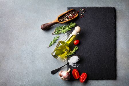 Culinary background with kitchen slate board, herbs and various spices. Empty place for menu or recipe. Top view.の写真素材