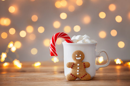 Gingerbread man, cup of hot cocoa with marshmallow and Christmas cane. Greeting card.