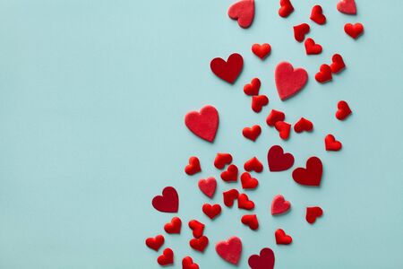 Valentine day card or banner. Many red hearts on blue background top view. Flat lay style.の写真素材