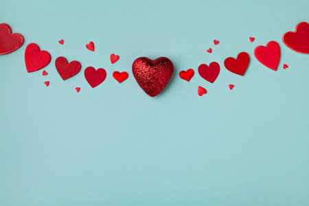 Valentine day garland. Red hearts on blue background. 