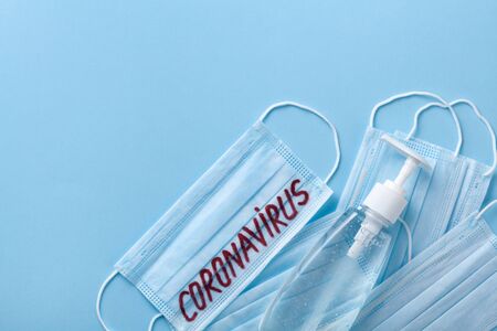 Sanitizer gel or antibacterial soap and face mask for coronavirus preventive measure, top view. Corona virus concept.の写真素材