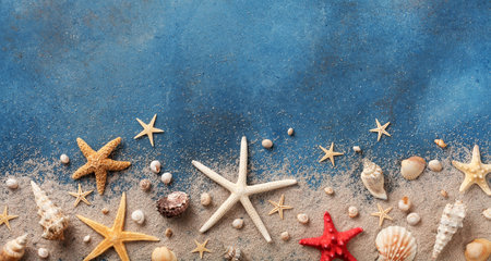 Seashell, starfish and beach sand on blue background. Summer holiday concept. Top view and flat lay....