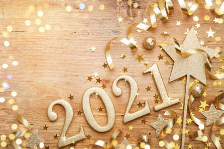 New Year celebration and festive background with golden numbers 2021, confetti stars and Christmas decorations top view.の写真素材