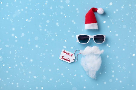 Creative Christmas background. Secret Santa card. Santa Claus hipster with hat, beard and...