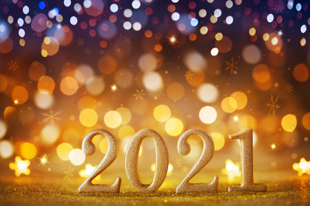 2021 New Year night scene against magic background from Christmas holiday lights and bokeh.