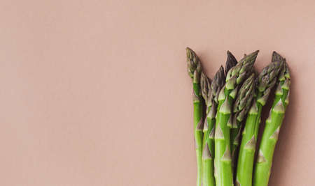 Beautiful floral arrangement of white narcissus flowers with empty paper note for wedding or greeting on peach background. Top view and flat lay style.の写真素材