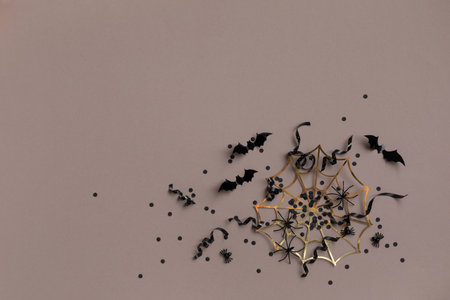 Halloween party decorations from bats, spider web and confetti top view. Happy halloween minimal holiday greeting card flat lay.の写真素材