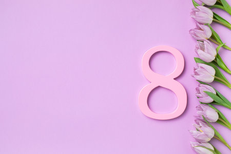 8 March. International Womens Day greeting card. Bouquet of fresh beautiful lilac tulip flowers on pastel table top view.の写真素材