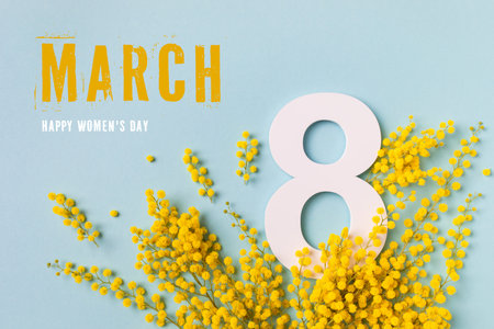 International Women Day on 8 March celebration with fresh spring mimosa flowers and number eight top view. Beautiful holiday greeting background with copy space.の写真素材