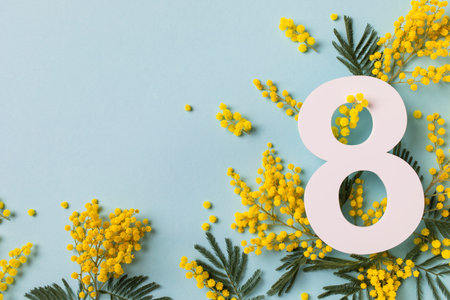 8 March celebration with number eight decorated with spring mimosa flowers top view. Happy Women Day...