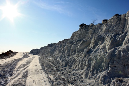 White as snow waste industry, road, sun and treeの写真素材