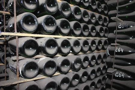 stacked up wine bottles in the cellar