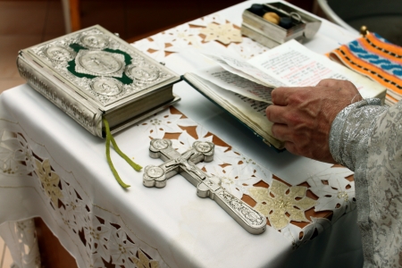 the prayer of the priest with the Bible and the Crossのeditorial素材