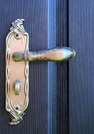 The iron doorhandle on the wooden doors closeの写真素材