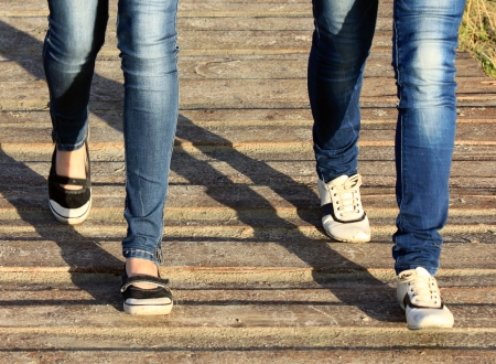 Close-up of female feet in sneakers running outdoorsの写真素材