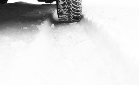 Winter tire on snow backgroundの写真素材