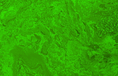 Abstract blurred green background with elements of spreading green paint and with effect of marble textureの写真素材