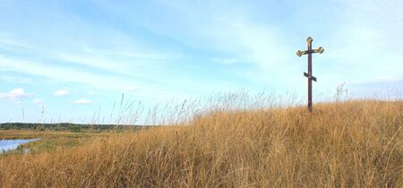 Christian cross on blue sky backgroundの写真素材