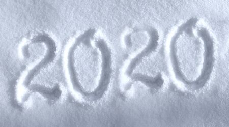Abstract Christmas photo for beautiful Christmas card with background inscription 2020 on real white snow in winter in cold weatherの写真素材