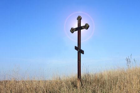 Christian cross on blue sky backgroundの写真素材