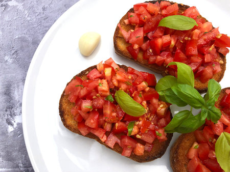 Italian bruschetta with tomatoes, basil and garlic on a plate