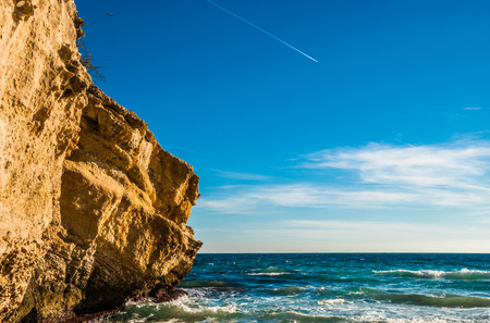 Rockcliff of Beautiful Iceland at Majorca Balearic Islands, Spain. Captured with Turquoise Sea Water Under Light Blue Sky on a Tropical Climate.の写真素材