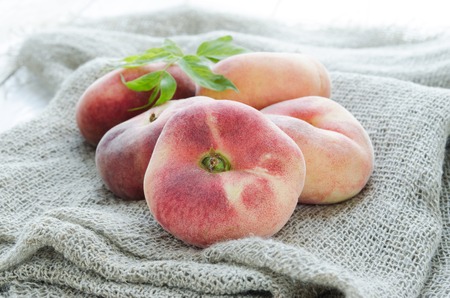 Saturn peaches or UFO, donut, flat peachesの写真素材
