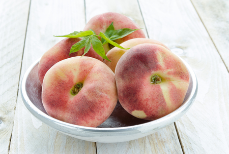 Saturn peaches or UFO, donut, flat peachesの写真素材