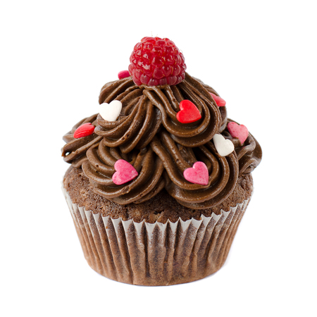 Chocolate cupcakes decorated with sugar hearts and raspberryの写真素材