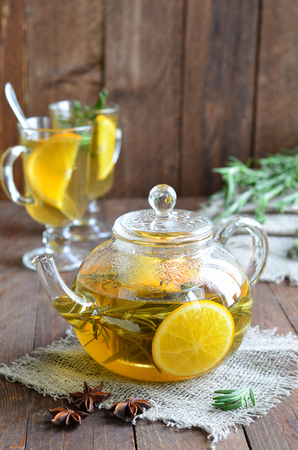 Healthy orange rosemary tea on wooden backgroundの写真素材