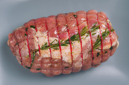 Raw Uncooked Pork, Rolled Meat with Herbs and Seasoningの写真素材