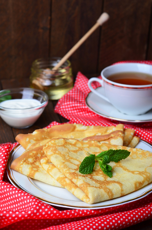 Delicious Homemade Pancakes with honey on plateの写真素材