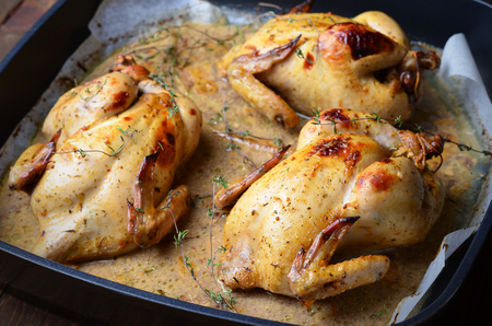 Whole Roasted Chicken with sauce on baking trayの写真素材
