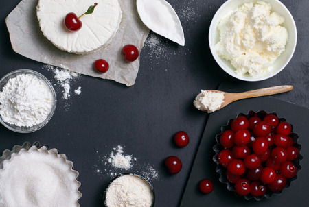 Dairy Products, Flour, Sugar and Cherries on Black Background, copy spaceの写真素材