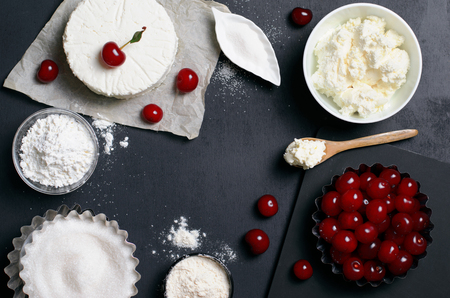 Dairy Products, Flour, Sugar and Cherries on Black Background, copy spaceの写真素材