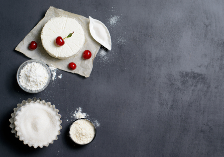 Dairy Products, Flour, Sugar and Cherries on Black Background, copy spaceの写真素材