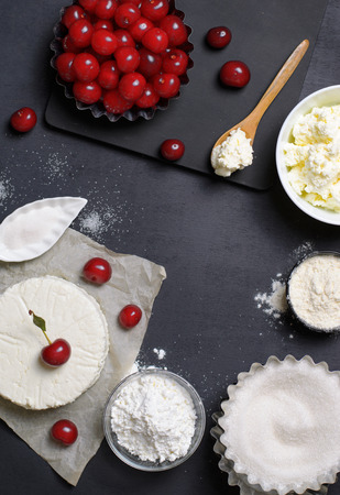 Dairy Products, Flour, Sugar and Cherries on Black Background, copy spaceの写真素材