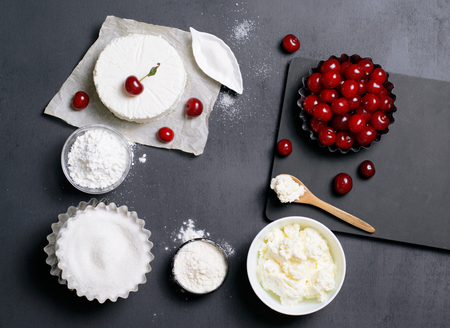 Dairy Products, Flour, Sugar and Cherries on Black Background, copy spaceの写真素材