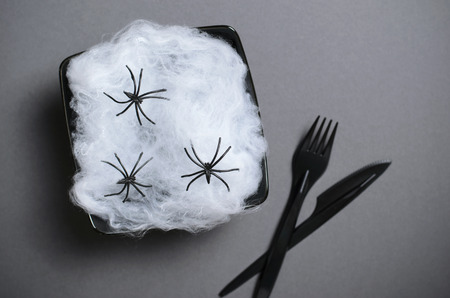 Top View of Halloween Plate with Cobweb and Spiders on Dark Background, Halloween Holiday Party Dinner Conceptの写真素材