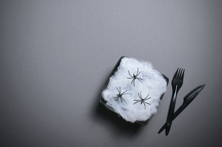 Top View of Halloween Plate with Cobweb and Spiders on Dark Background, Halloween Holiday Party Dinner Conceptの写真素材
